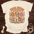Cream t-shirt with "Dog Mom Energy" text, a dog, and flowers.