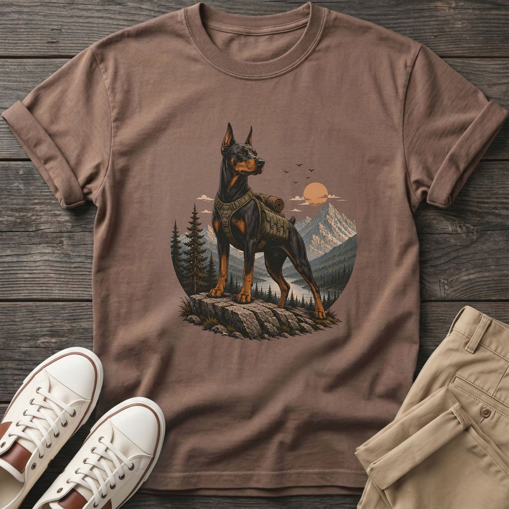 Brown t-shirt with Doberman on a mountain peak under the sun.