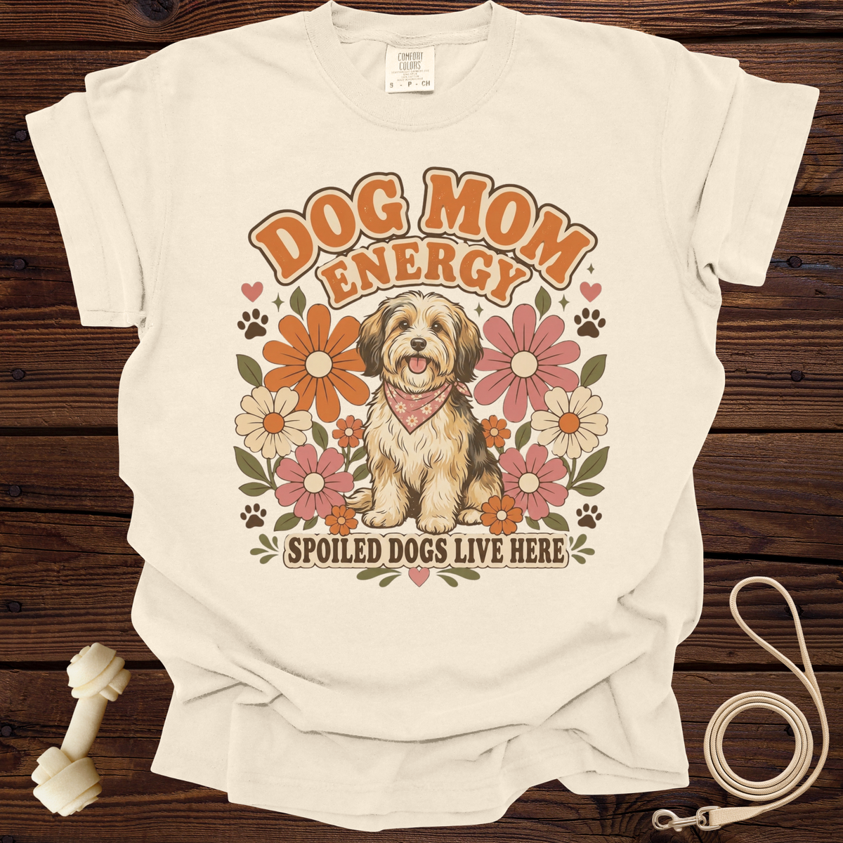 Cream t-shirt with "Dog Mom Energy" text, a dog, and flowers graphic.