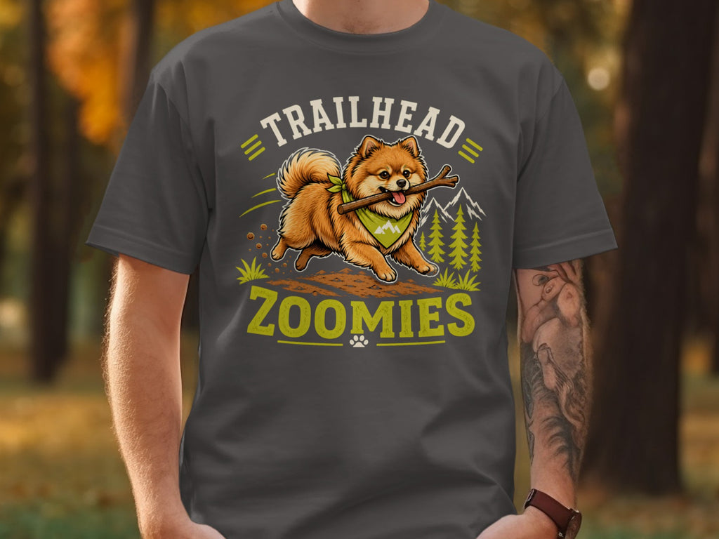 Pomeranian dog with stick on shirt text "TRAILHEAD ZOOMIES".