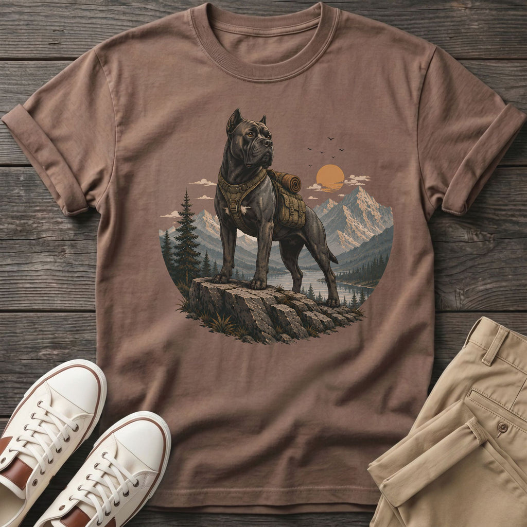 Brown t-shirt with a graphic of a dog wearing a backpack on a mountain overlook.