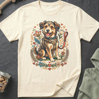 T-shirt featuring a smiling dog in a harness surrounded by flowers and hearts.
