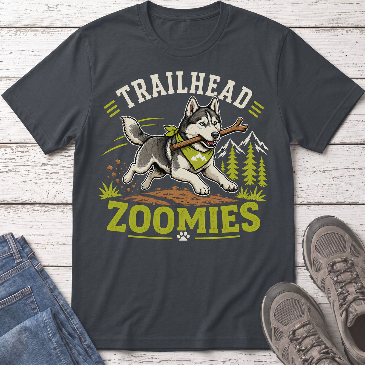 Husky with stick in mouth, text "TRAILHEAD ZOOMIES" on dark grey t-shirt.