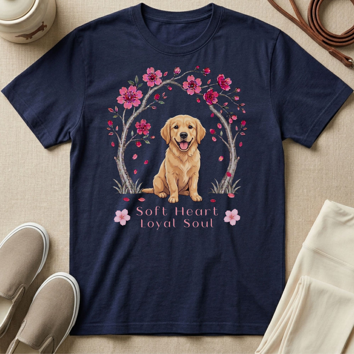 Navy t-shirt with a happy golden retriever sitting under a cherry blossom tree.