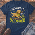 Golden retriever running with stick on t-shirt with "Trailhead Zoomies" text.
