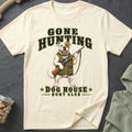 Cream t-shirt with a bulldog in hunting gear holding a rifle and text "GONE HUNTING DOG HOUSE HUNT CLUB".