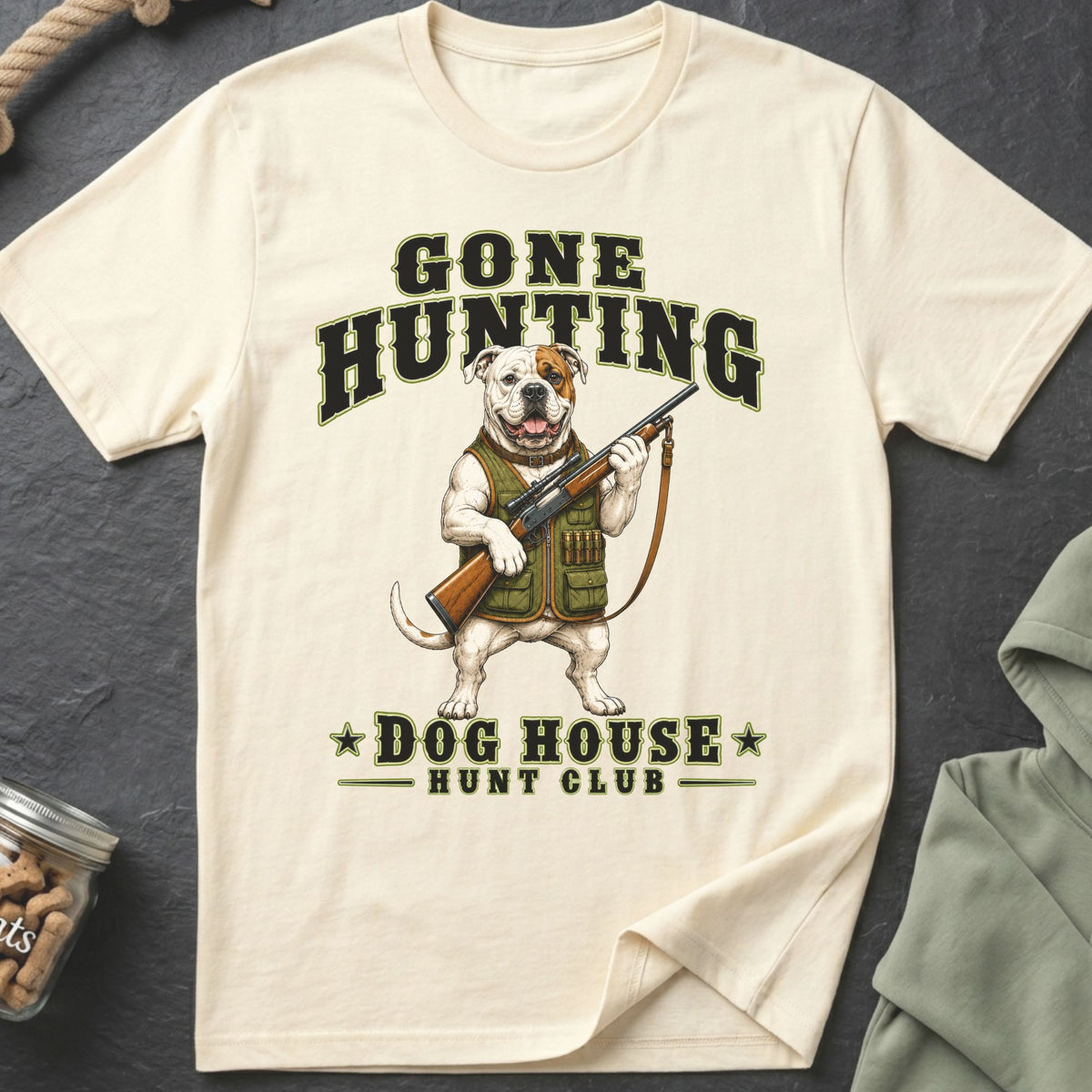 Cream t-shirt with a bulldog in hunting gear holding a rifle and text "GONE HUNTING DOG HOUSE HUNT CLUB".