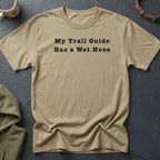 Tan t-shirt with black text reading "My Trail Guide Has a Wet Nose".