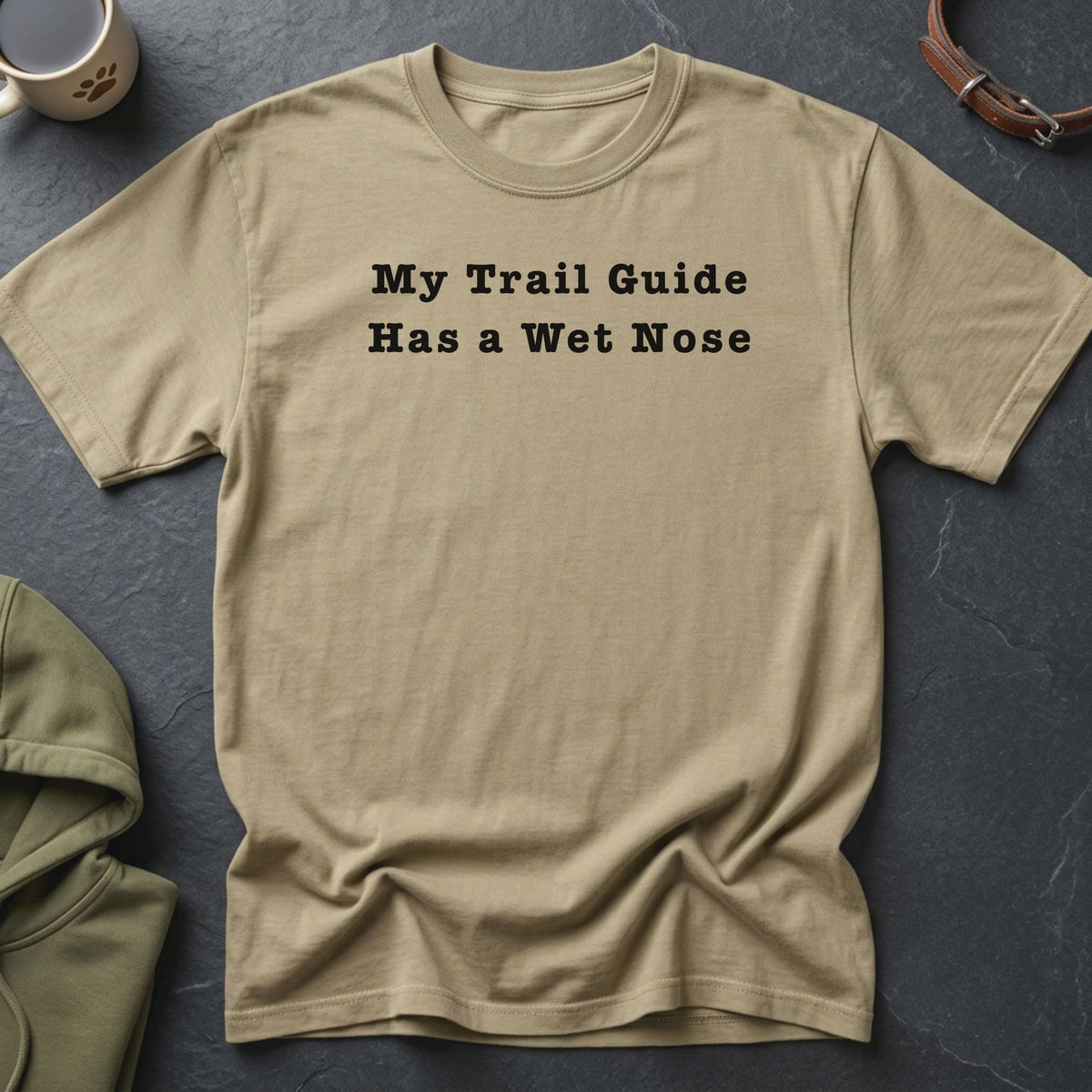 Tan t-shirt with black text reading "My Trail Guide Has a Wet Nose".