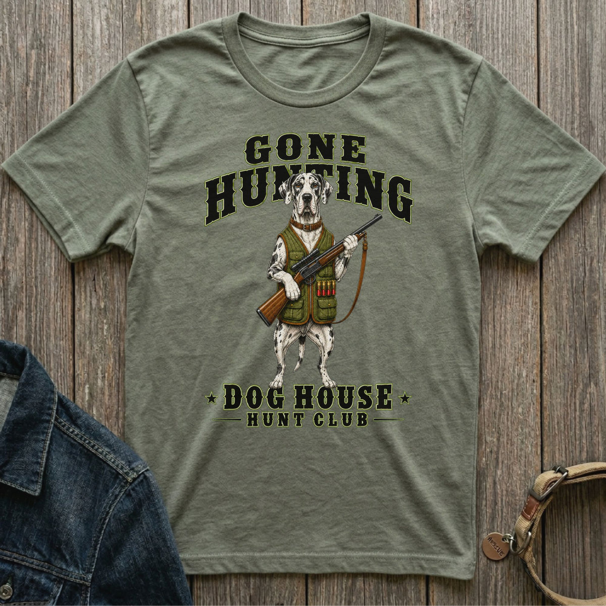 Green t-shirt with a Dalmatian holding a rifle, text reads "GONE HUNTING DOG HOUSE HUNT CLUB".