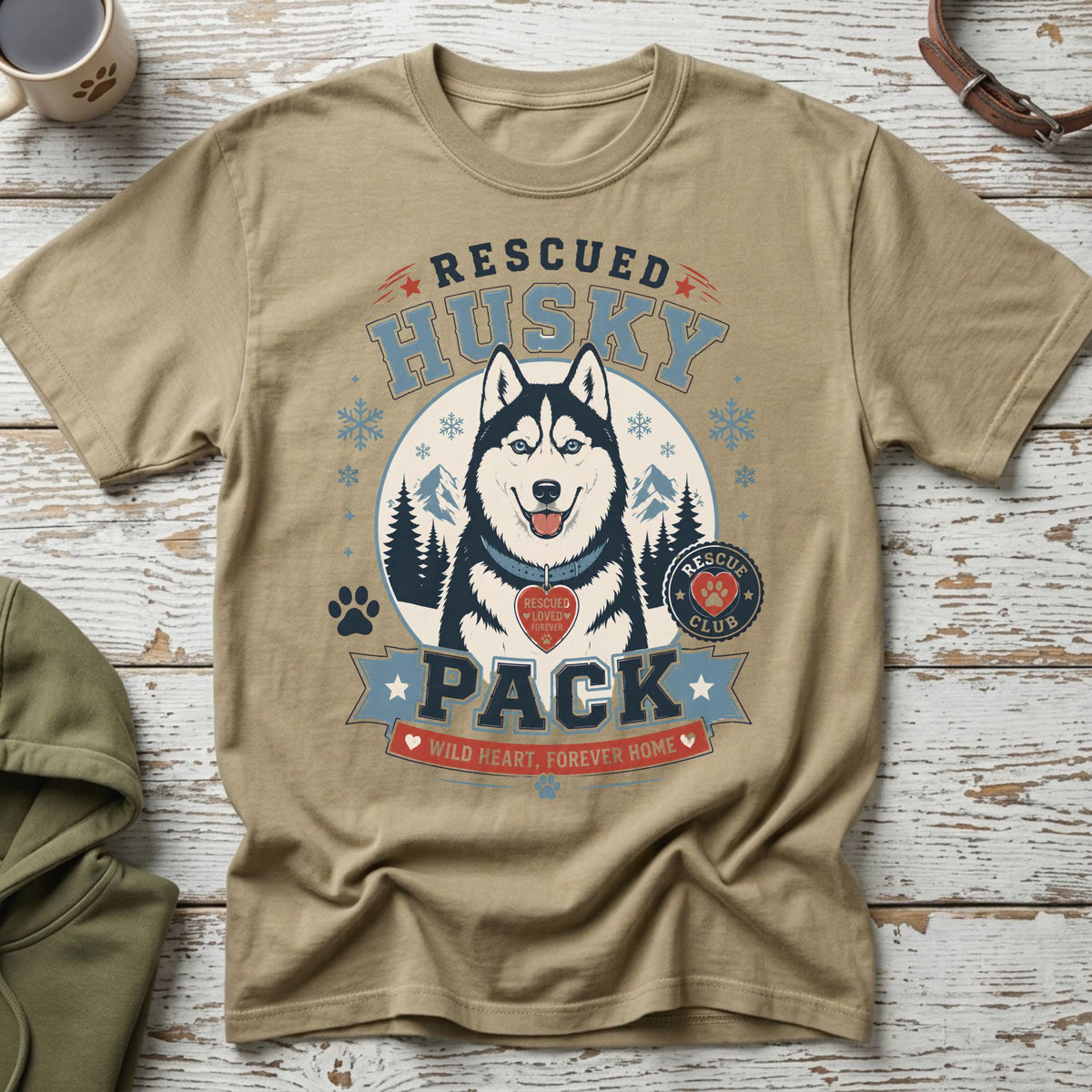 Tan t-shirt with a graphic of a husky, mountains, and text.