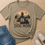 Graphic tee with woman, two dogs, and "Dog Mom" text with mountain landscape.