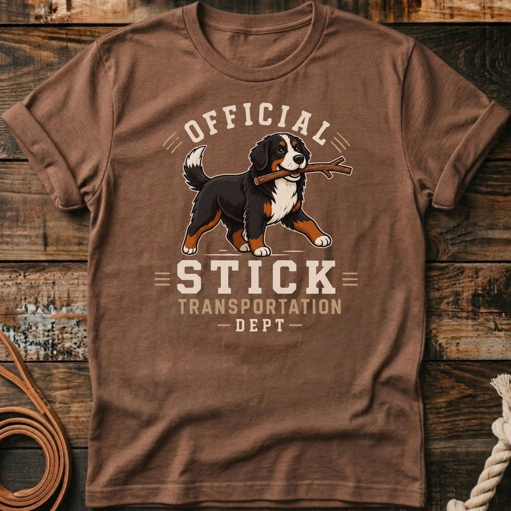 Bernese Mountain Dog with stick, "Official Stick Transportation Dept" text on brown shirt.