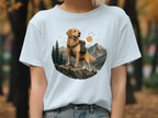 Golden retriever with backpack on cliff overlooking mountains and lake