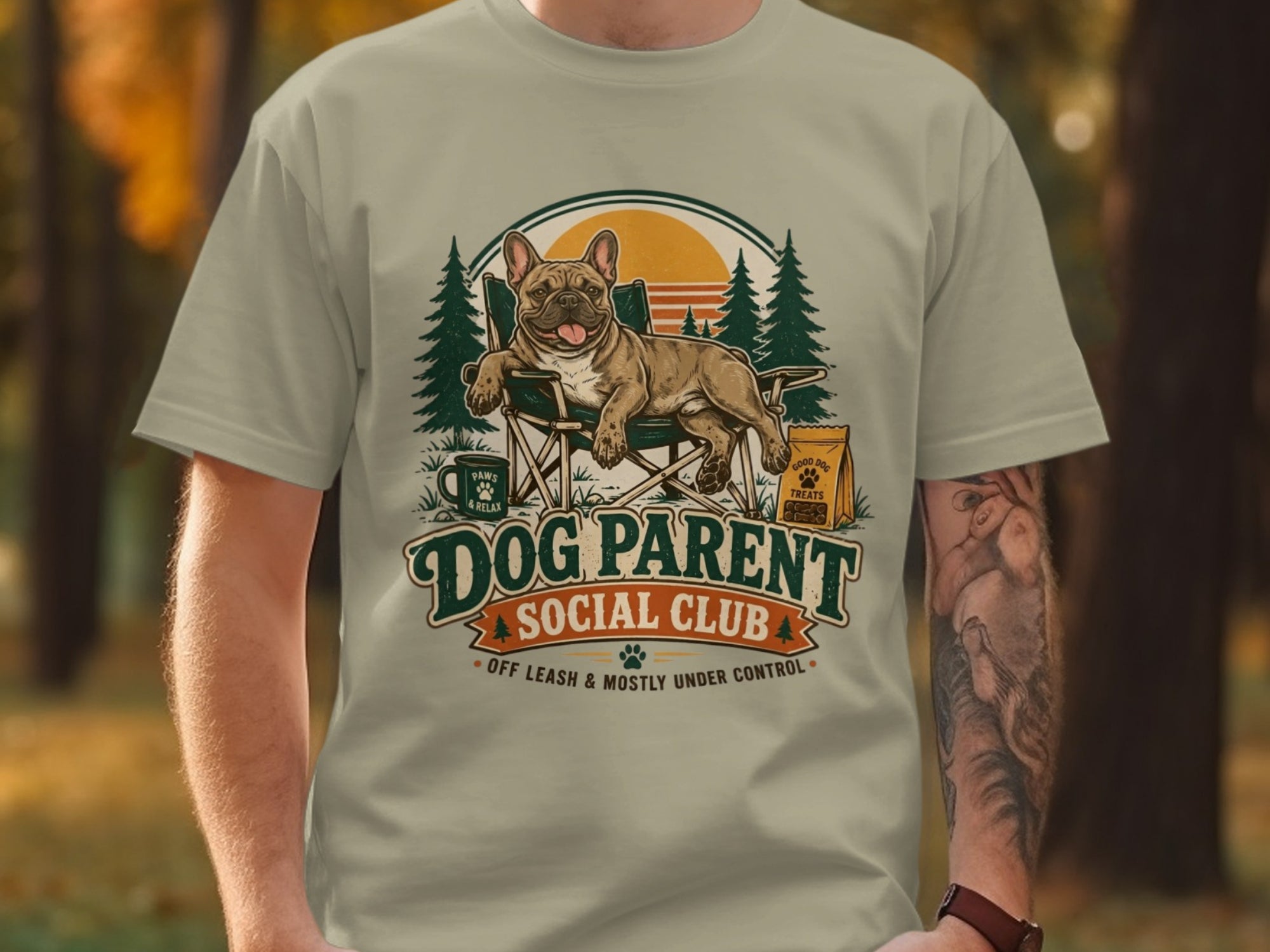 French Bulldog in camping chair, "Dog Parent Social Club" text, and dog treats bag.