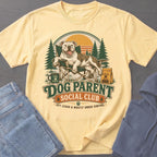 Yellow t-shirt with a pitbull relaxing in a camping chair and text "Dog Parent Social Club".