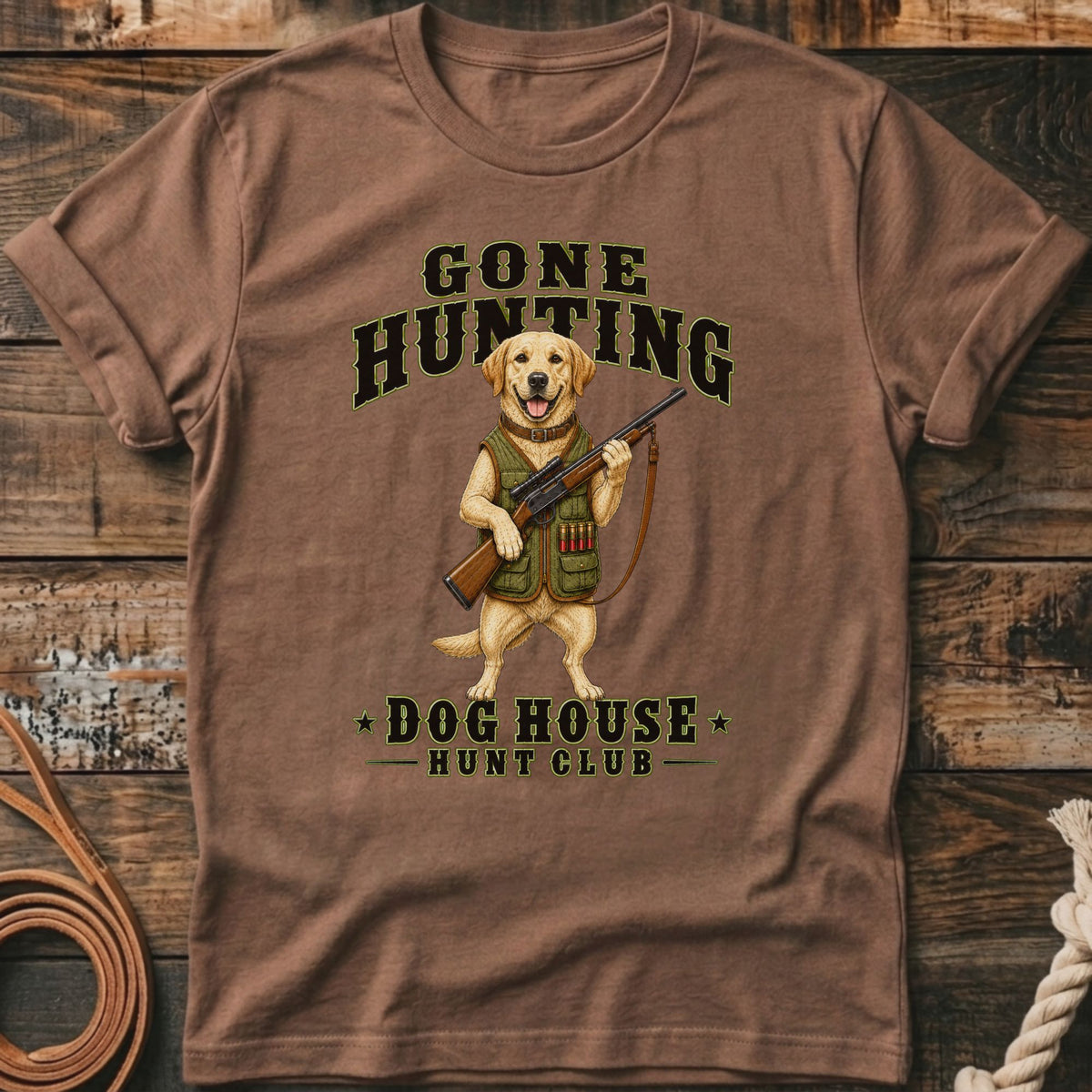 T-shirt graphic of a dog holding a rifle, reading "Gone Hunting" and "Dog House Hunt Club".