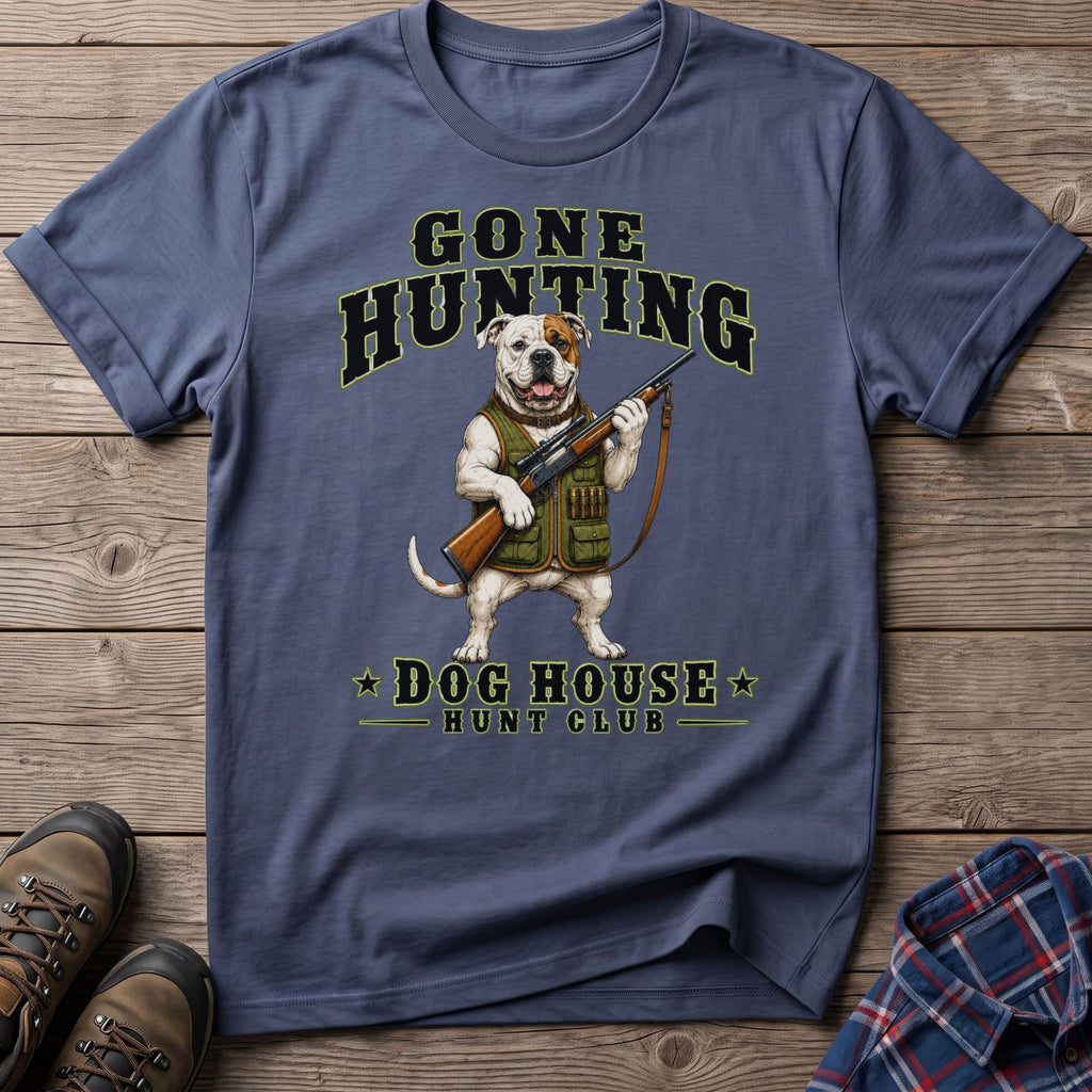 Dog wearing hunting vest and holding rifle with text "Gone Hunting Dog House Hunt Club".