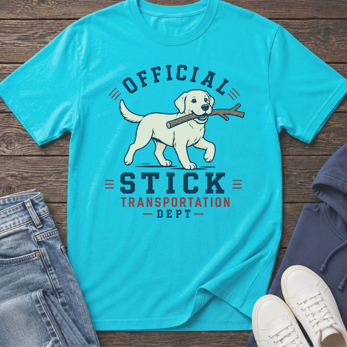 Aqua t-shirt with yellow lab carrying stick, text "Official Stick Transportation Dept".
