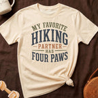 Cream t-shirt with "My favorite hiking partner has four paws" graphic.
