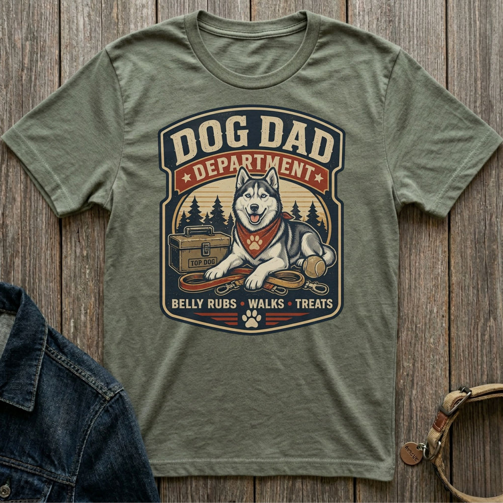 Dog Dad Department graphic on olive green t-shirt with husky, leash, ball, and toolbox.