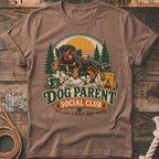Brown t-shirt with Rottweiler lounging in a camp chair, "Dog Parent Social Club" text.