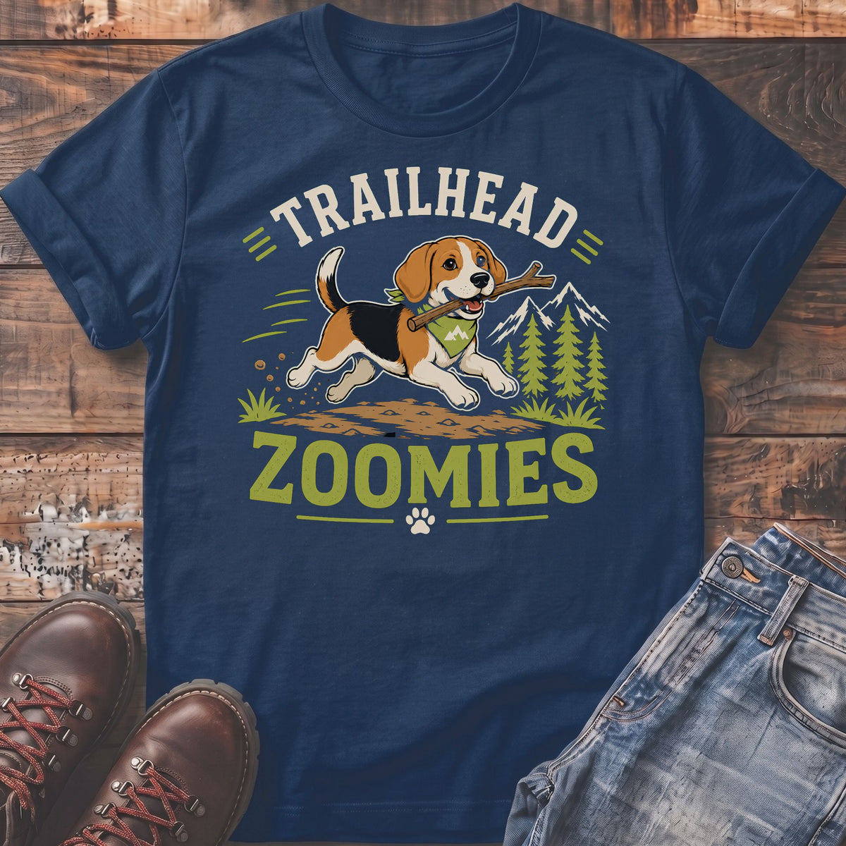 Beagle with stick under "TRAILHEAD ZOOMIES" text on navy t-shirt with mountains.