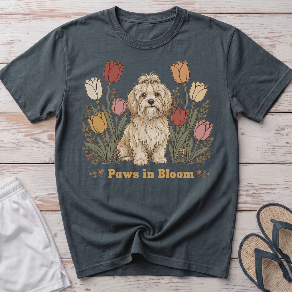 T-shirt with a cute fluffy dog surrounded by colorful tulips and the text "Paws in Bloom".