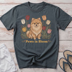 Pomeranian dog surrounded by tulips with text "Paws in Bloom".