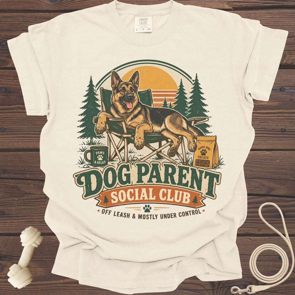 German Shepherd relaxing in a chair with "Dog Parent Social Club" text.