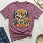 Dog sitting in a camping chair, text reads "Dog Parent Social Club".